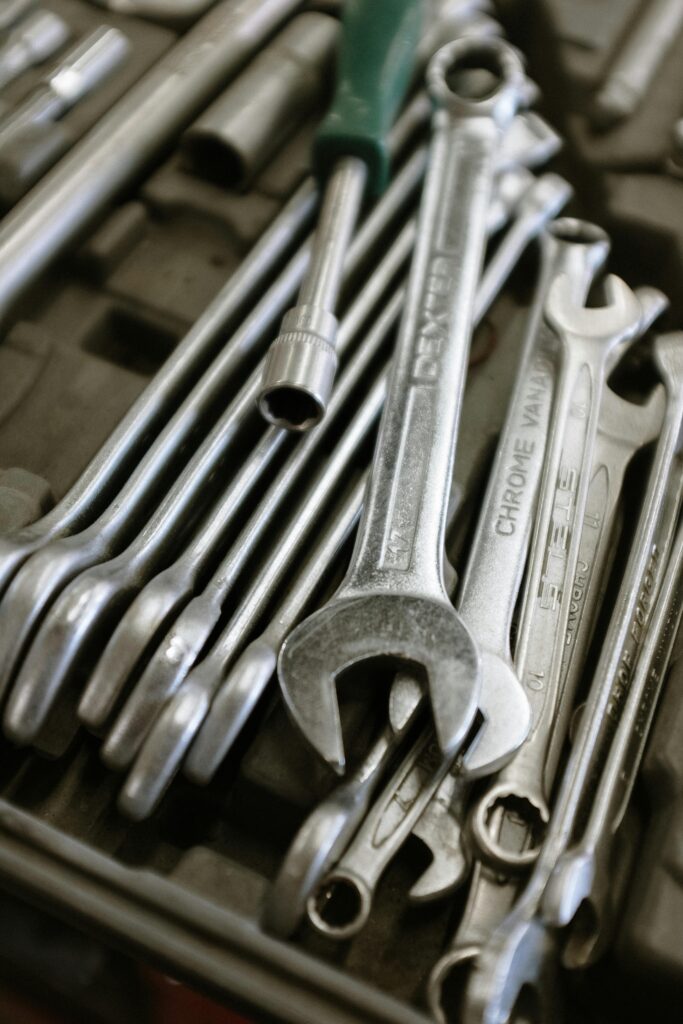 A detailed image of wrenches and tools neatly arranged in a workshop setting.